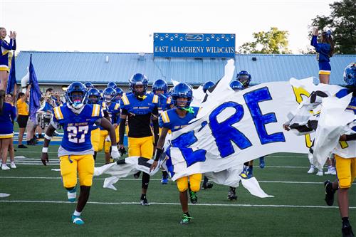 football team running on field
